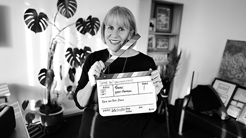 Sue Anstiss folding a film clapper board.