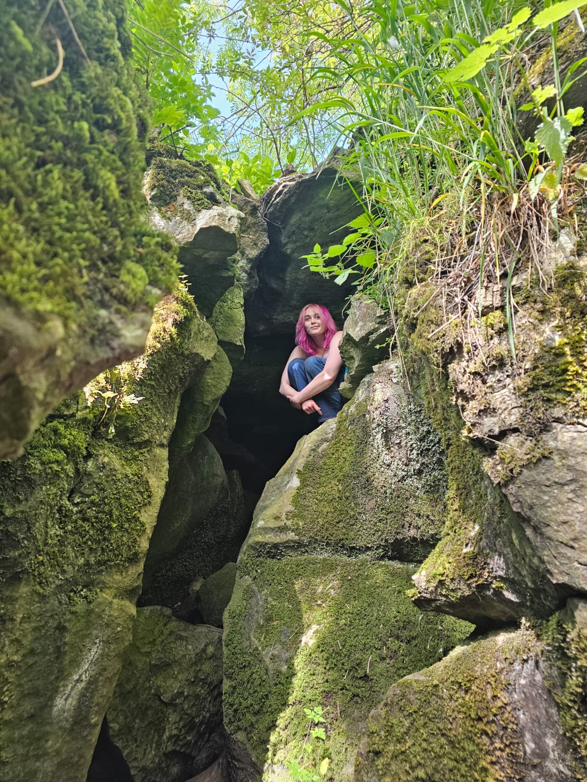 Holly Sykes sitting in the middle of a large rock formation