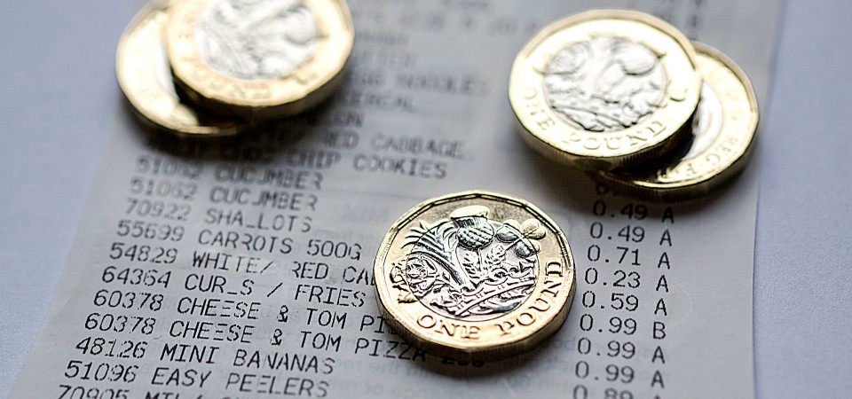 Pound coins sitting on top of a food reciept