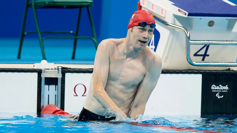 Paralympic male swimmer Sascha Kindred sitting on ropes of pool post-race at Rio 2016 Paralympic Games.