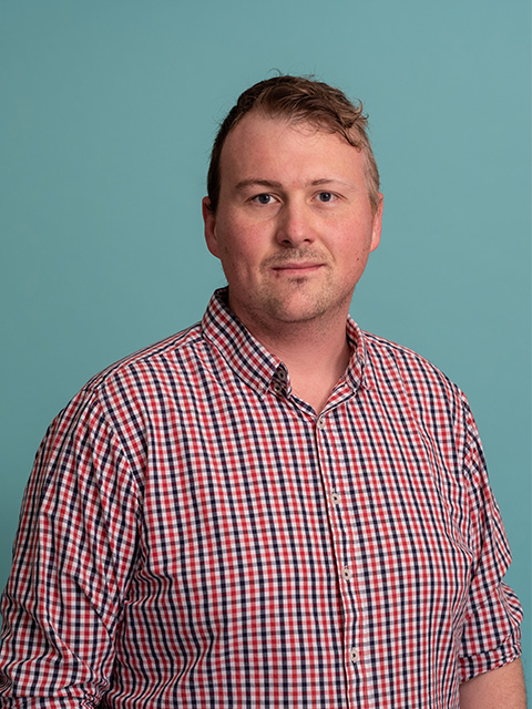 white male in green t-shirt with text 'harrison'