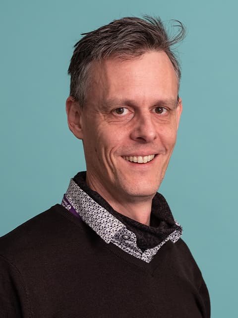 headshot of paul smiling