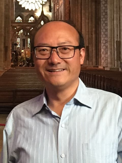 headshot of Wen-Hua in a church