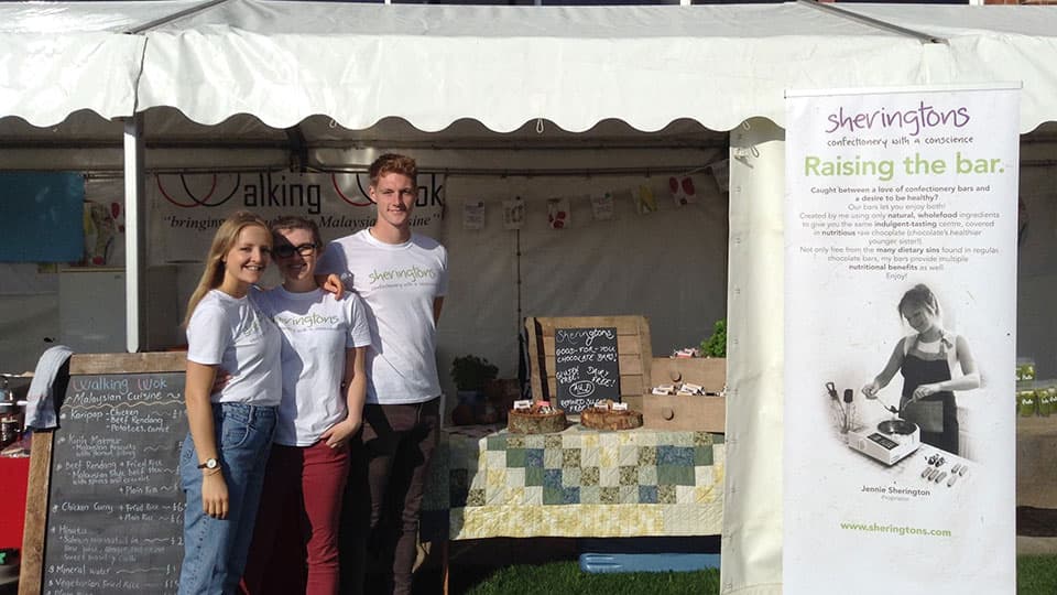 Sheringtons Chocolate team standing outside their market stall.