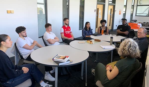 Professor Jeffrey Wooldridge chatting to staff and students.