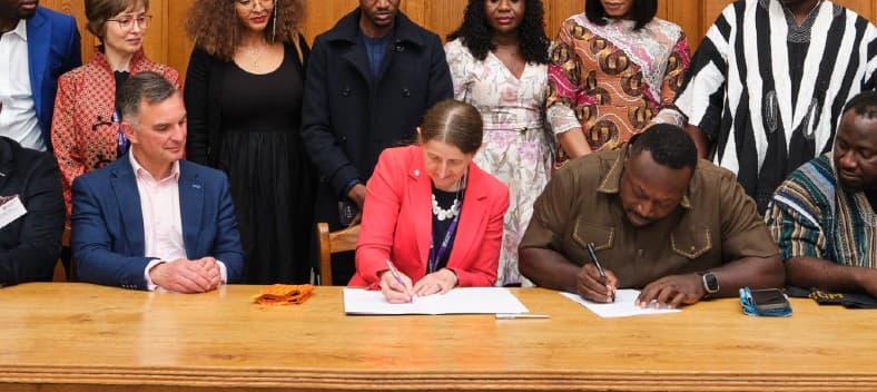 Rachel Thomson and George Opare-Addo signing a Memorandum of Understanding.