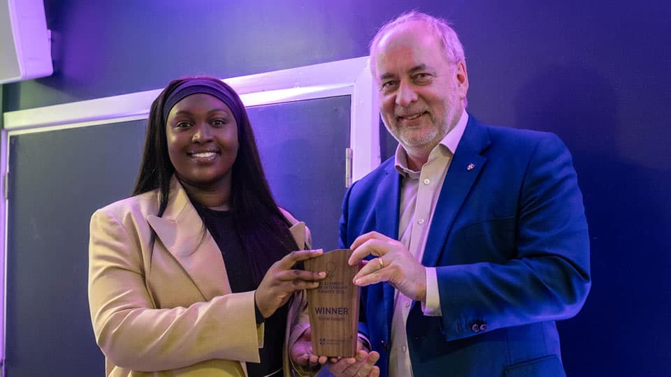 Toyin Kukoyi receiving an award from Nick Jennings.