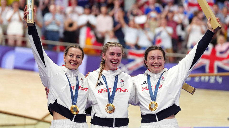 UK womens sprint team stood together wearing gold medals