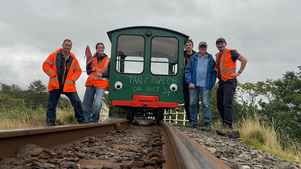 Carewyn stood by the Wickham trolley with other people from the railway