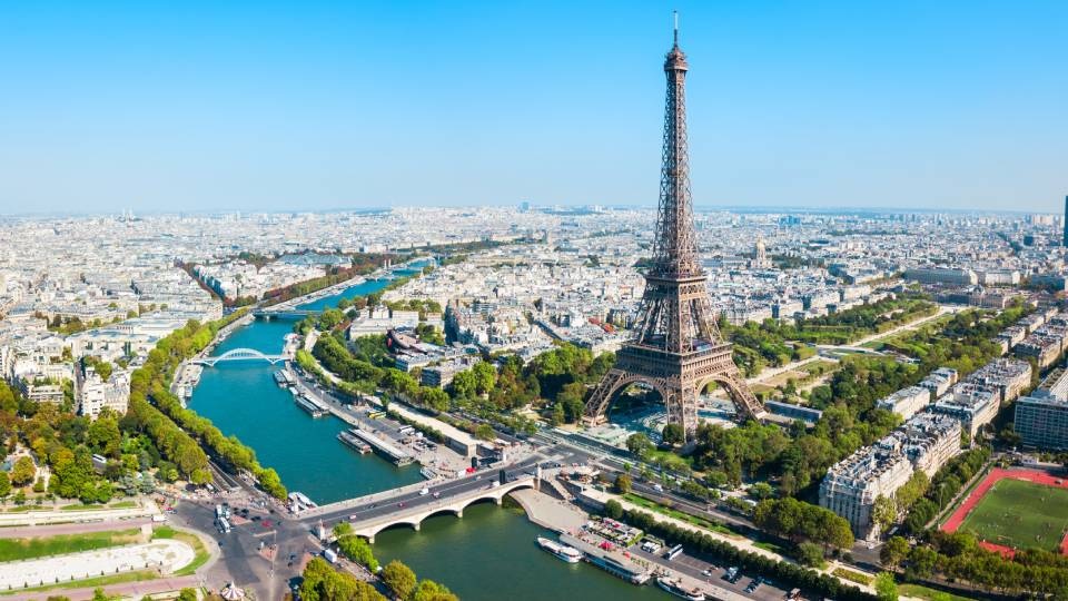 An aerial shot of Paris, France with the Eiffel Tower prominent against the skyline