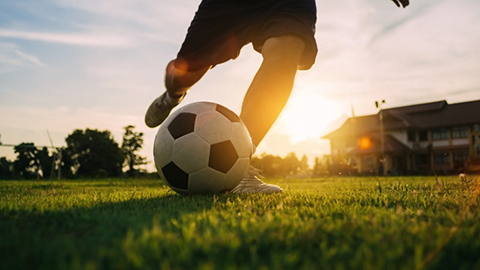 Playing football in the park. Image by Getty