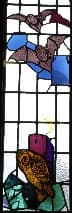 Stained glass panel from the Rutland Building featuring an owl, castle and two bats.