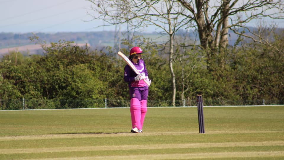 a cricketer holding a cricket bat