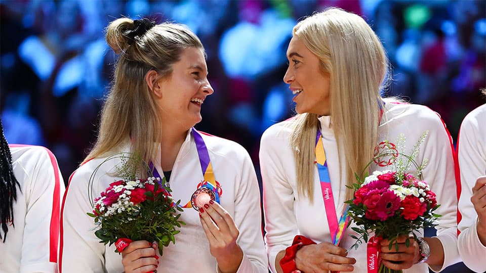 players with winning medals and flowers
