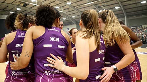 the team on the court with their backs to the camera