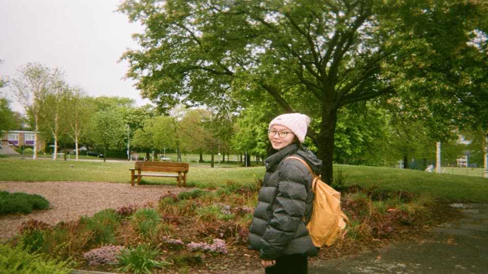 A female student stood in front of a tree