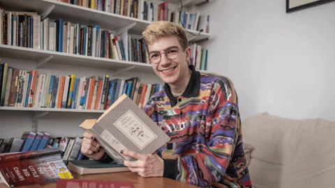 A student sitting down with a book