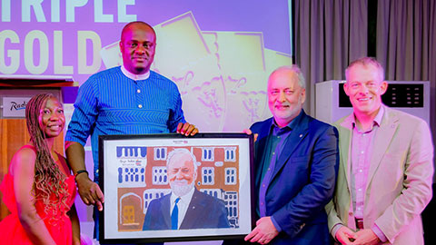 Professor Nick Jennings CB FREng FRS being presented with a gift/painting of himself at Loughborough University's reception in West Africa