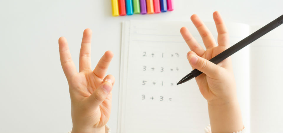 Child using fingers to count