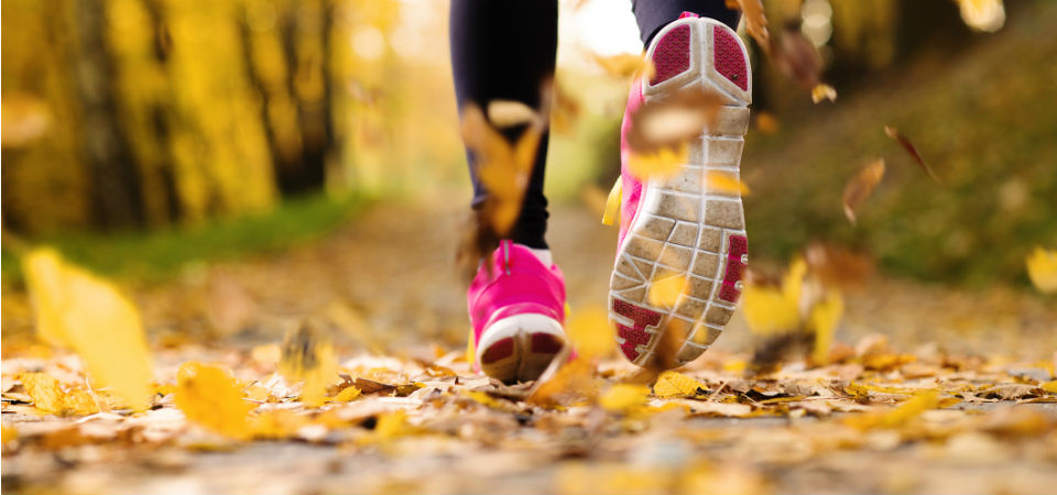 girl running through leaves