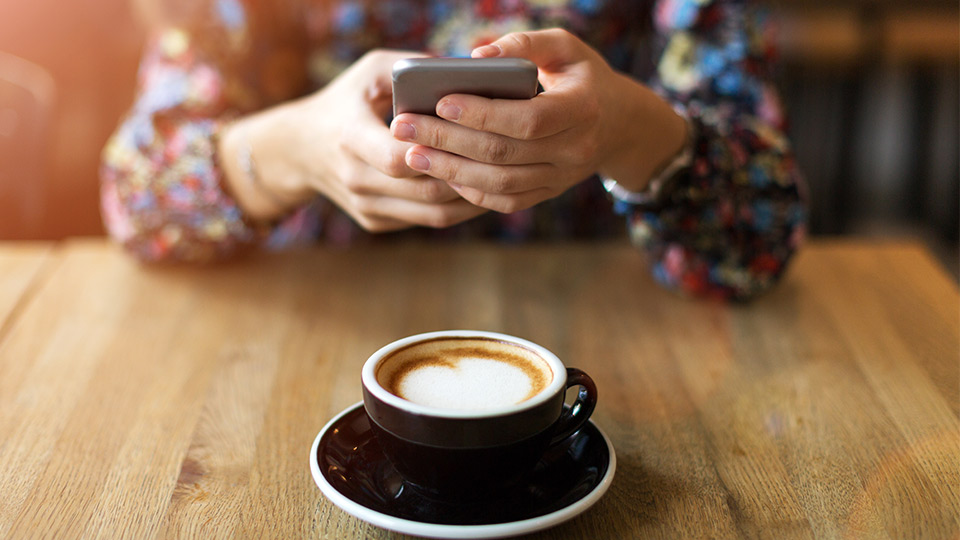 Mobile phone user in a coffee shop 