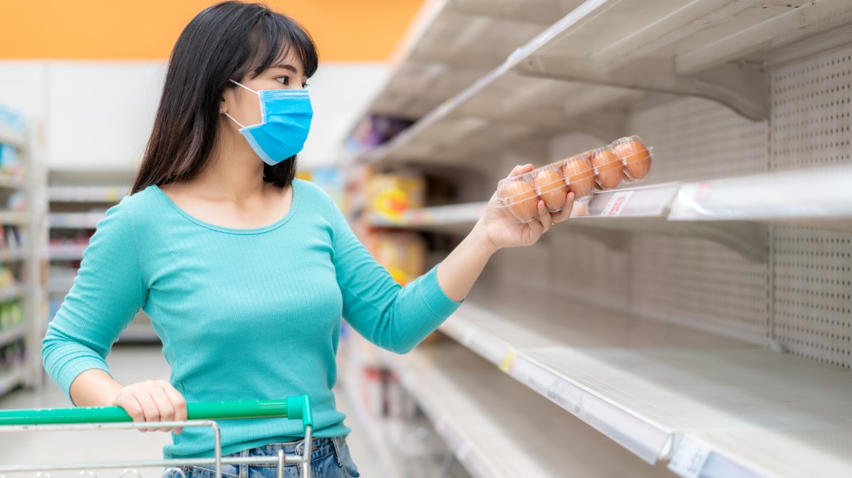 Woman buying eggs in a supermarket