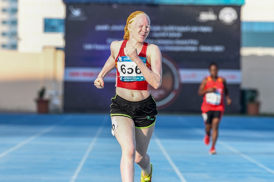 female African athlete sprints on track 