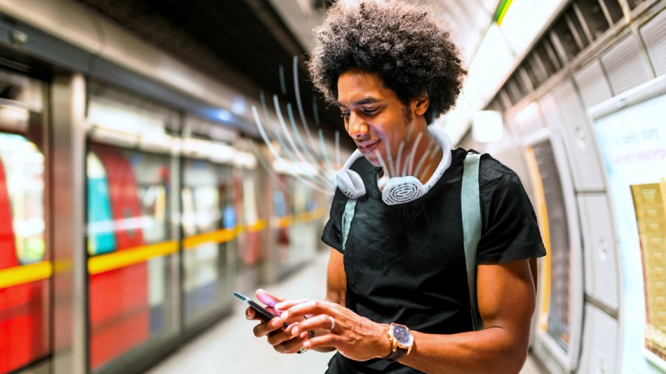 A man at an underground train platform with the Aerate product around his neck