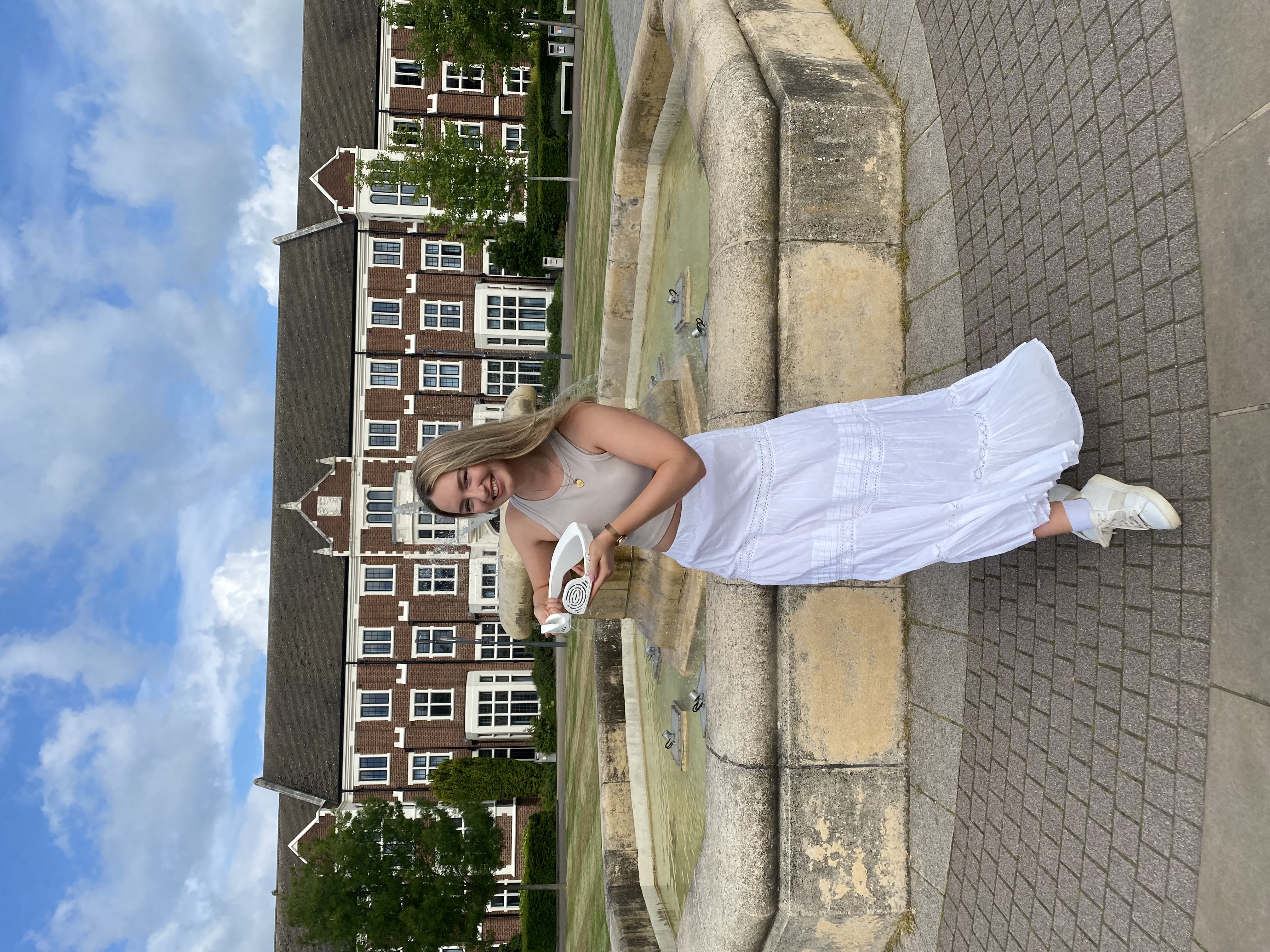 Mia holding Aerate outside of Loughborough University's Hazlerigg building