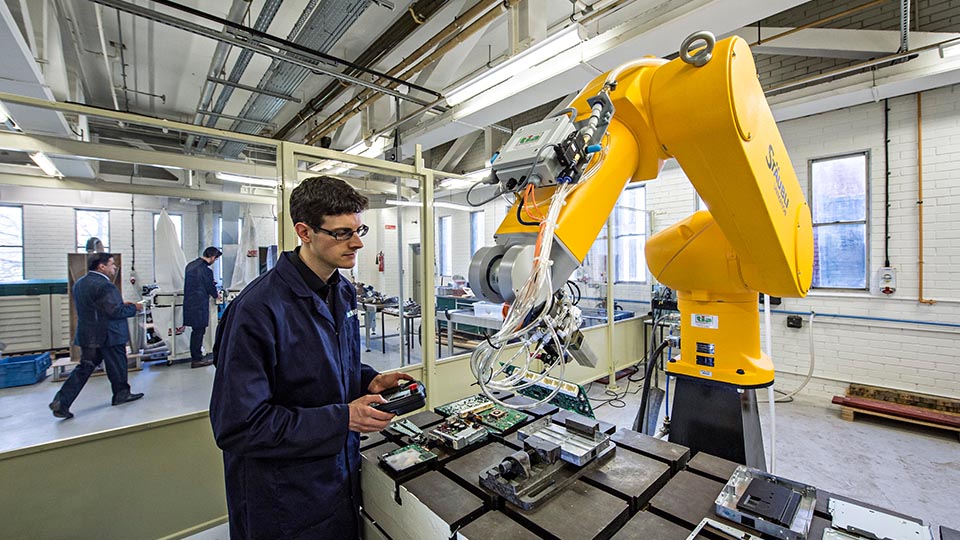 photo of a man working with a machine