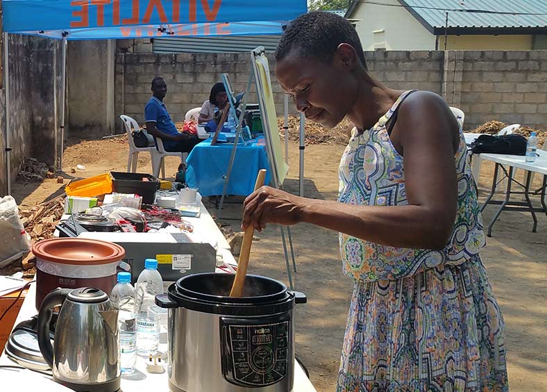 A woman cooking with electric alternatives. 