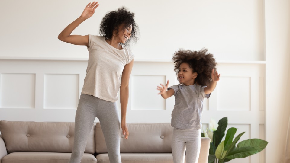 a child exercising with their parent 