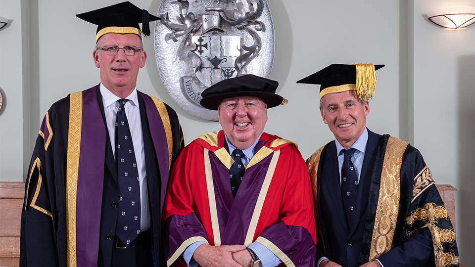 Photo of Peter Harrison, VC Bob Allison, and Lord Seb Coe at the 2018 Graduation