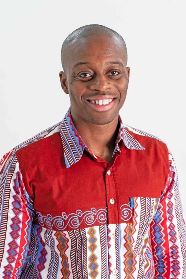 Professional headshot of Dr James Esson, who is smiling and staring directly at the camera