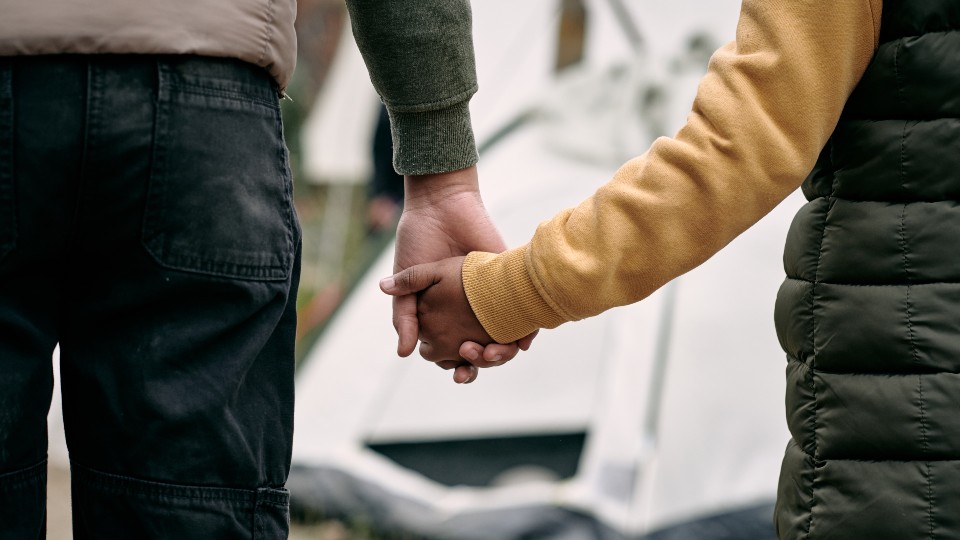 a child and parent holding hands