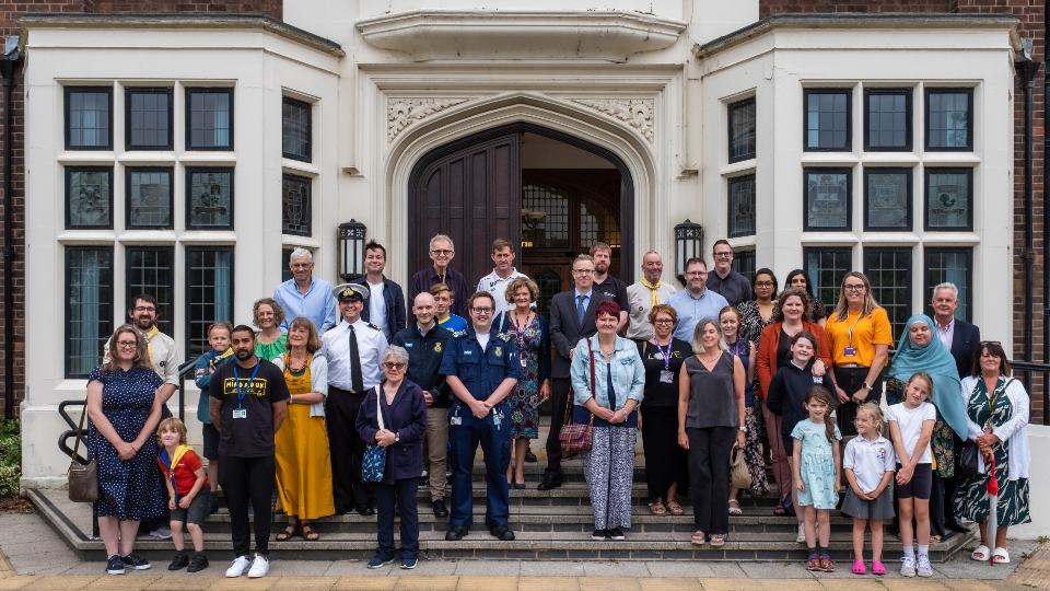 Recipients of the 2023 Community Donations Fund standing together in front of the entrance of the Hazlerigg building.