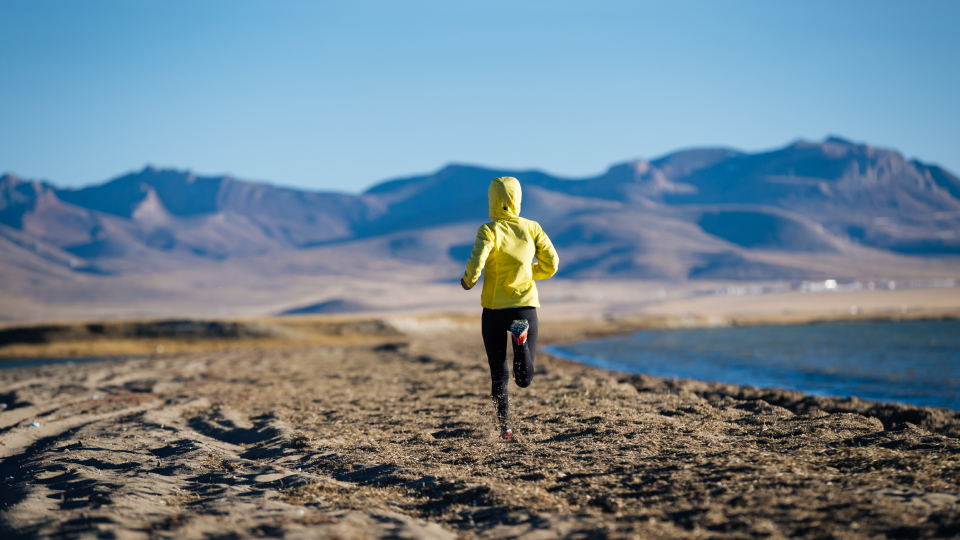 a marathon runner running through mountains 