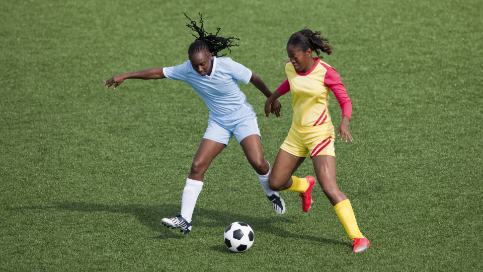 Women footballers play the sport