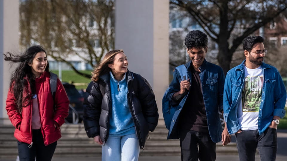 International students walking across Shirley Pearce square