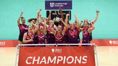 a sports team lifting a trophy