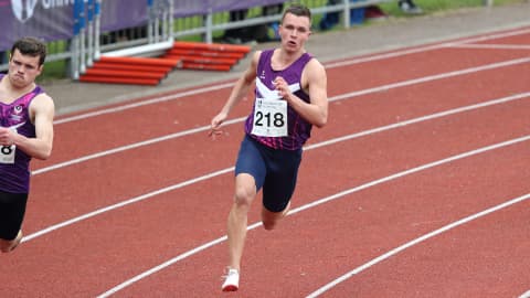 an athlete running around the track