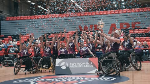 lightning basketball players lift the trophy