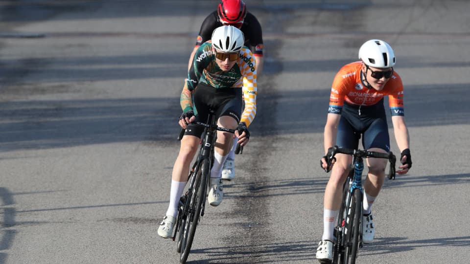 a close up of a man racing on a bike