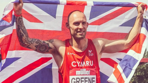 athlete dai greene with the union jack flag over his shoulders