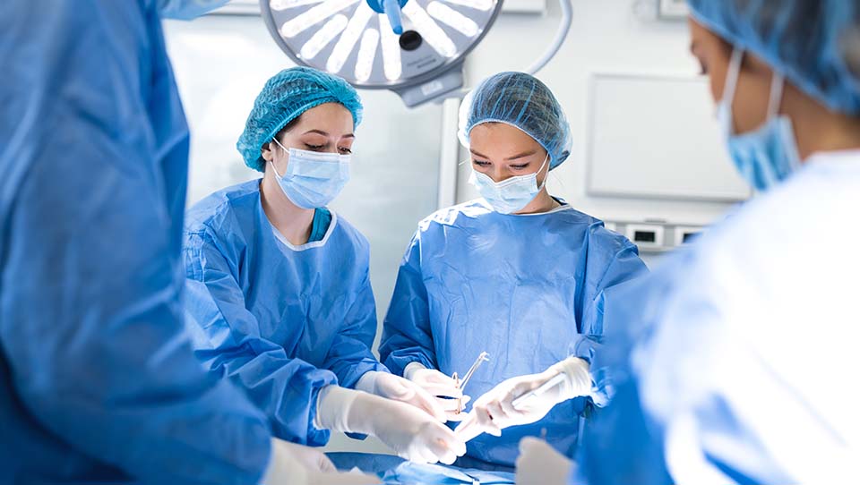 Two doctors conducting surgery on a patient