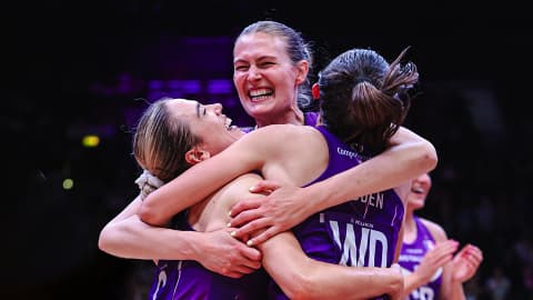 A group of netball players in a huddle