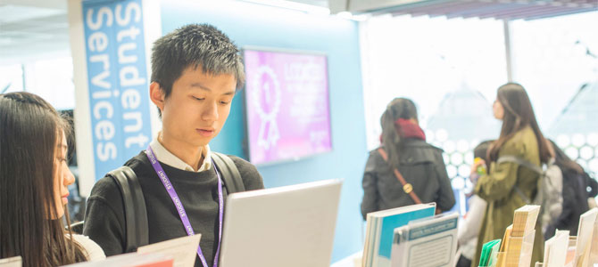 Students checking out literature in the Student Services foyer