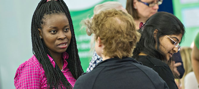 Image of research staff in discussion at the conference.