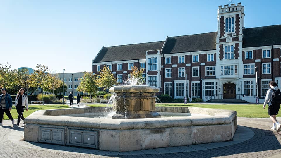 The fountain in front of Hazlerigg Building on a clear, sunny day.